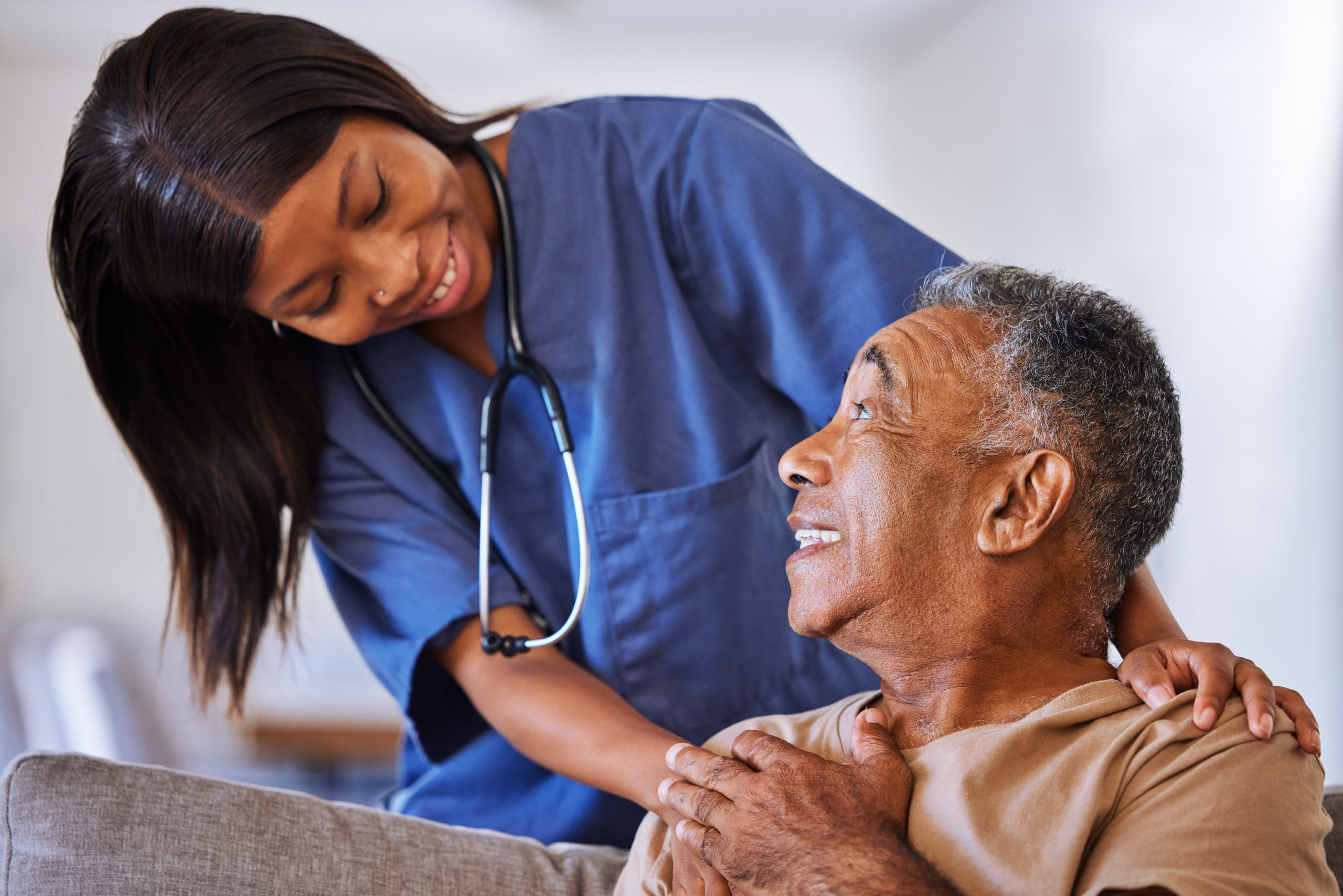 Brazilian senior man, volunteer nurse or support caregiver help with elderly in medical nursing hom.